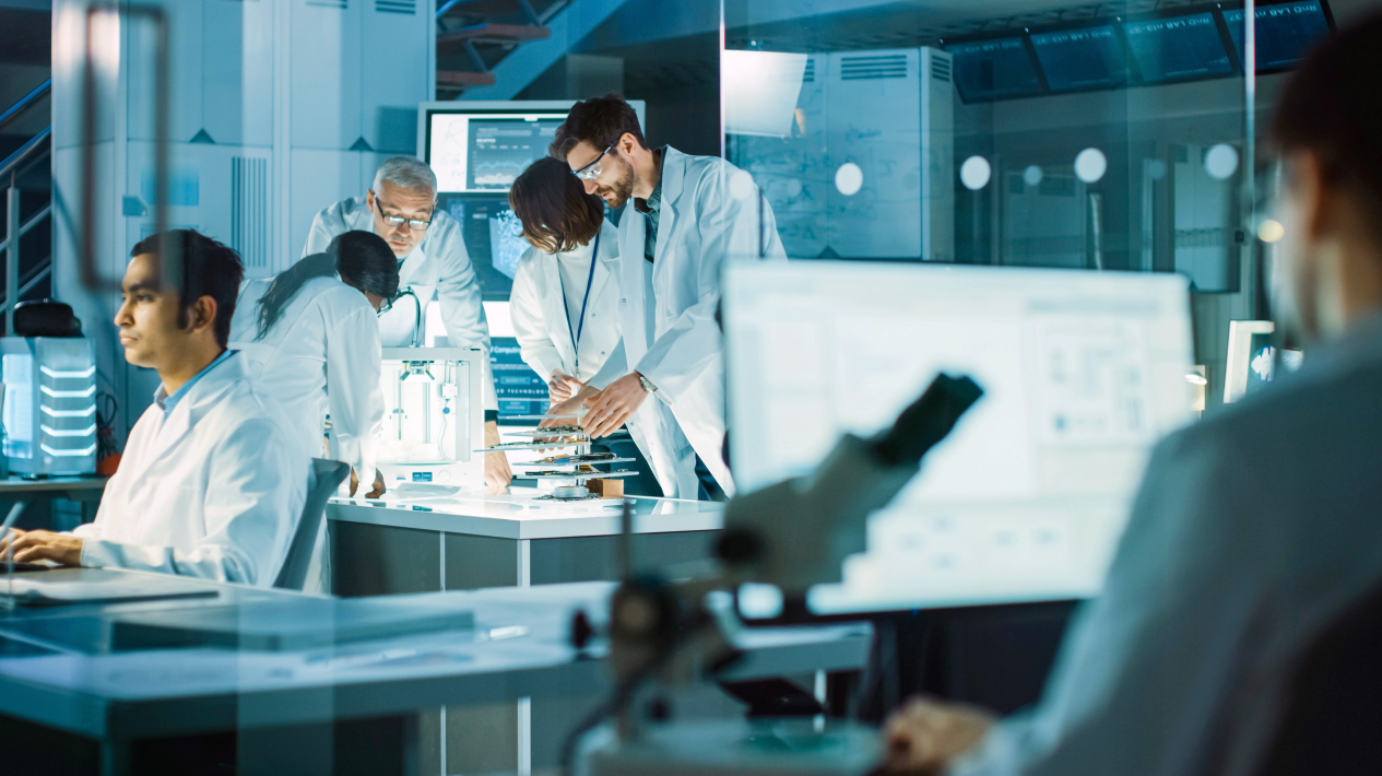 High-voltage substation with transformer equipment and electrical switchgear at night