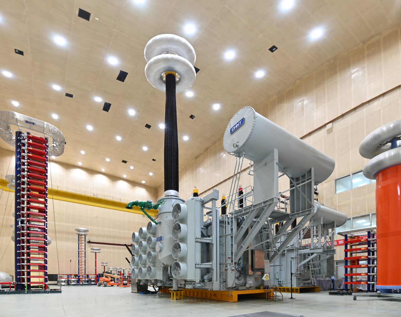 Project team standing in front of a high-voltage substation during nighttime commissioning work