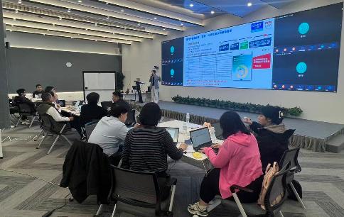 CHINT hosting an ESG capacity-building workshop with employees and partners attending a sustainability presentation in a conference setting.