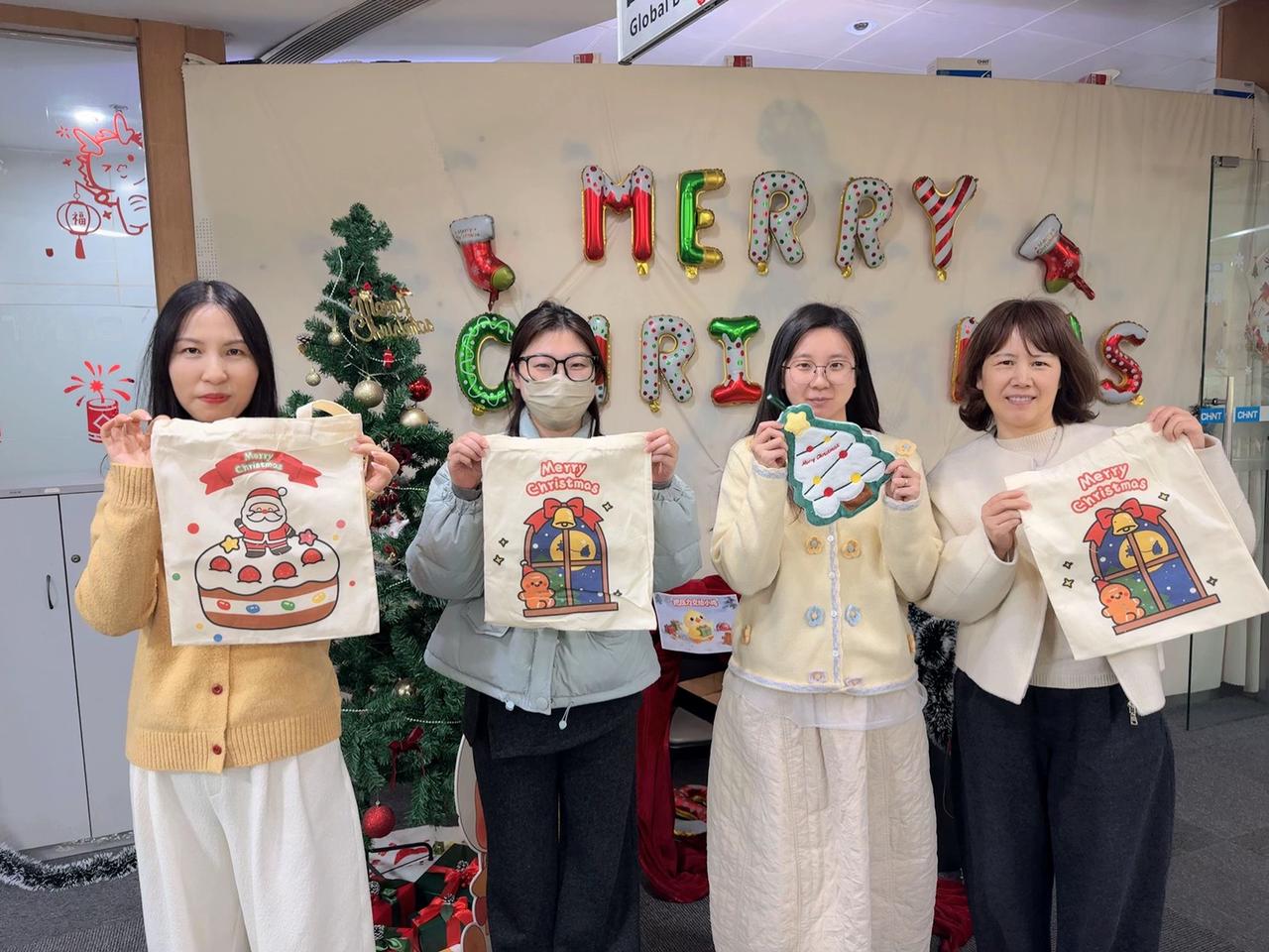 CHINT headquarters employees display Christmas gift bags during a festive celebration filled with warmth, smiles, and holiday cheer