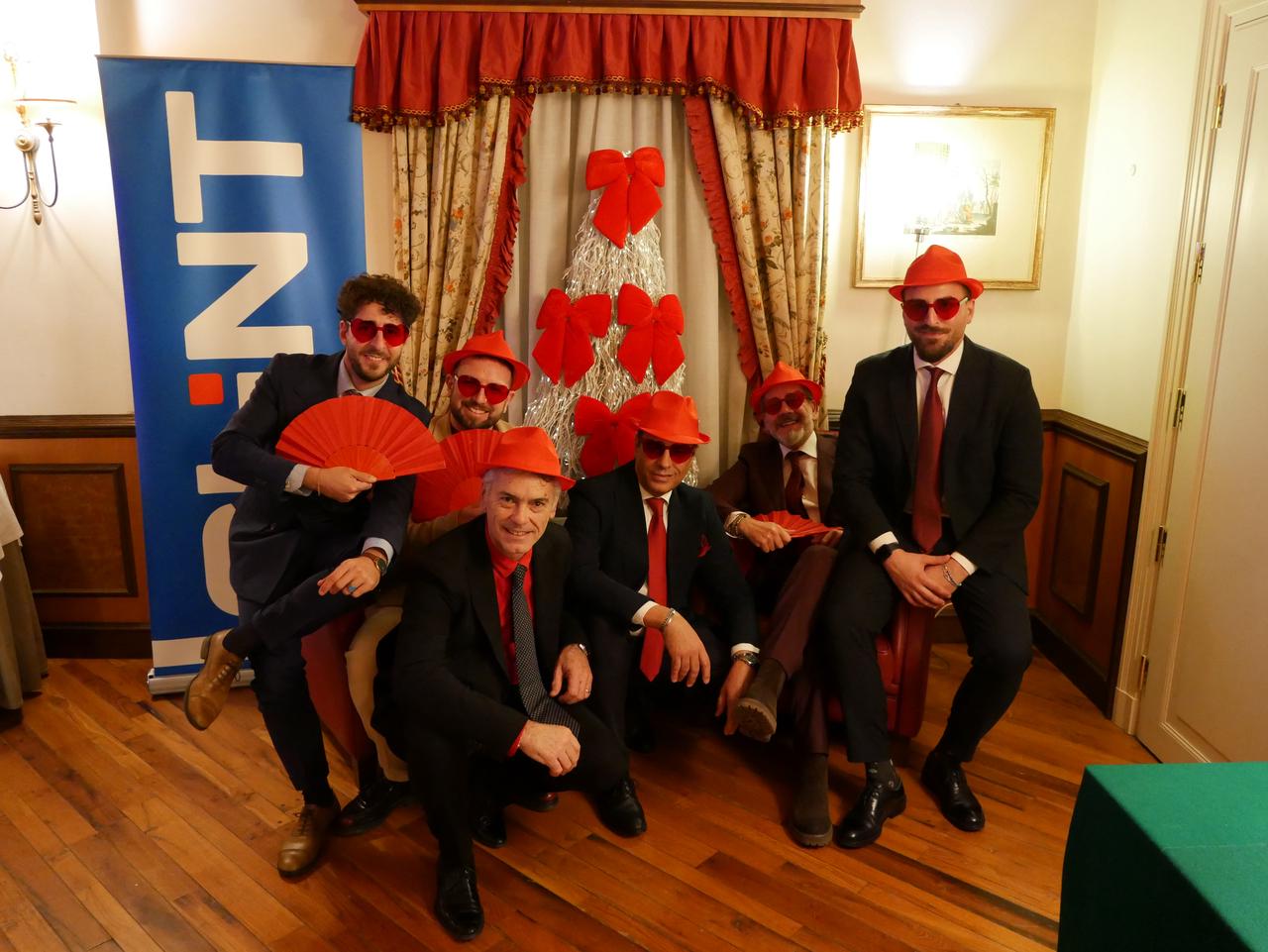 CHINT Italy team poses creatively in festive attire during Christmas celebrations, highlighting team spirit and camaraderie