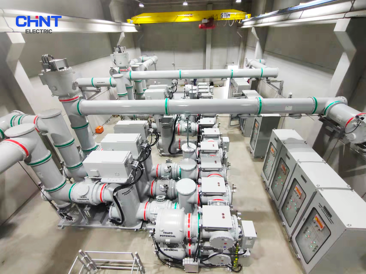 High-voltage substation with transformer equipment and electrical switchgear at night