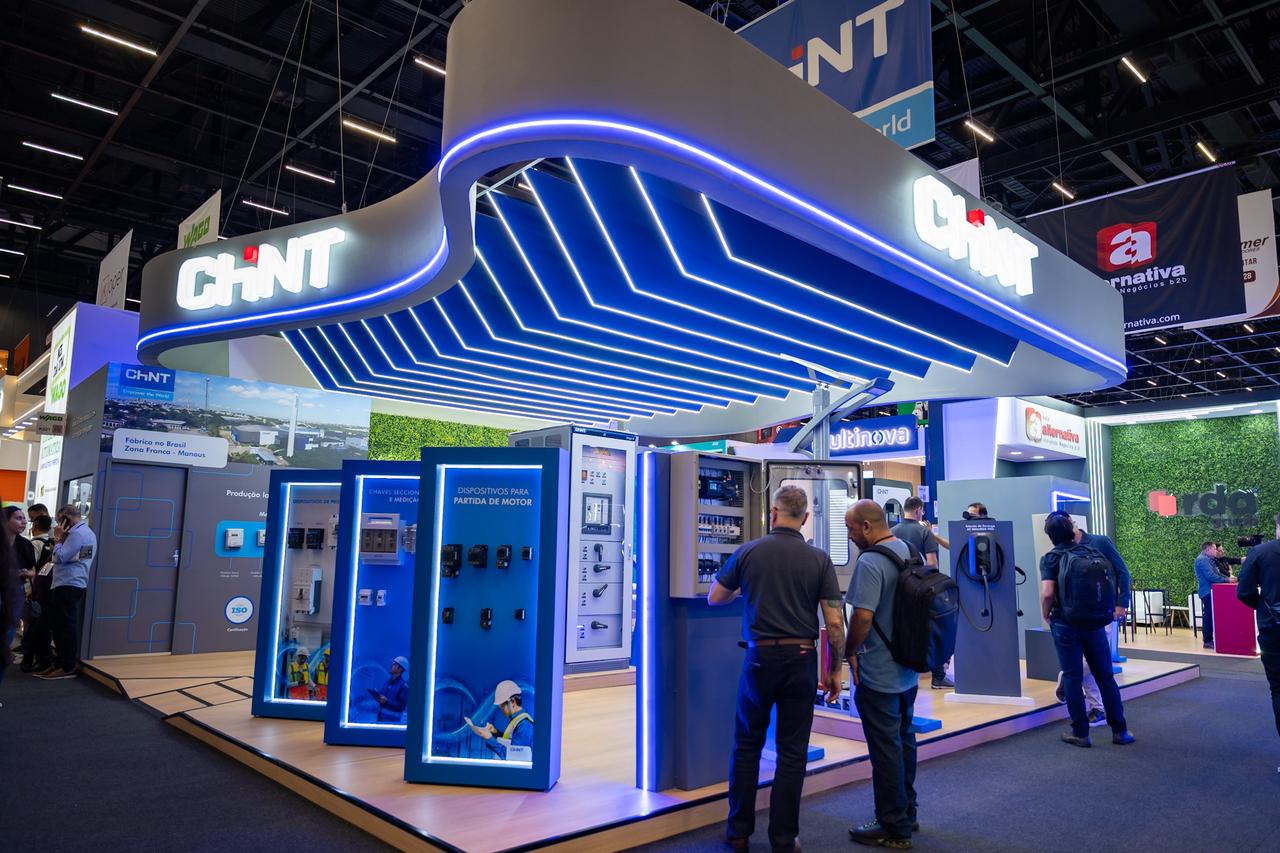 CHNT electric exhibition booth showcasing industrial switchgear, control panels, and electrical solutions at a trade show with visitors exploring products