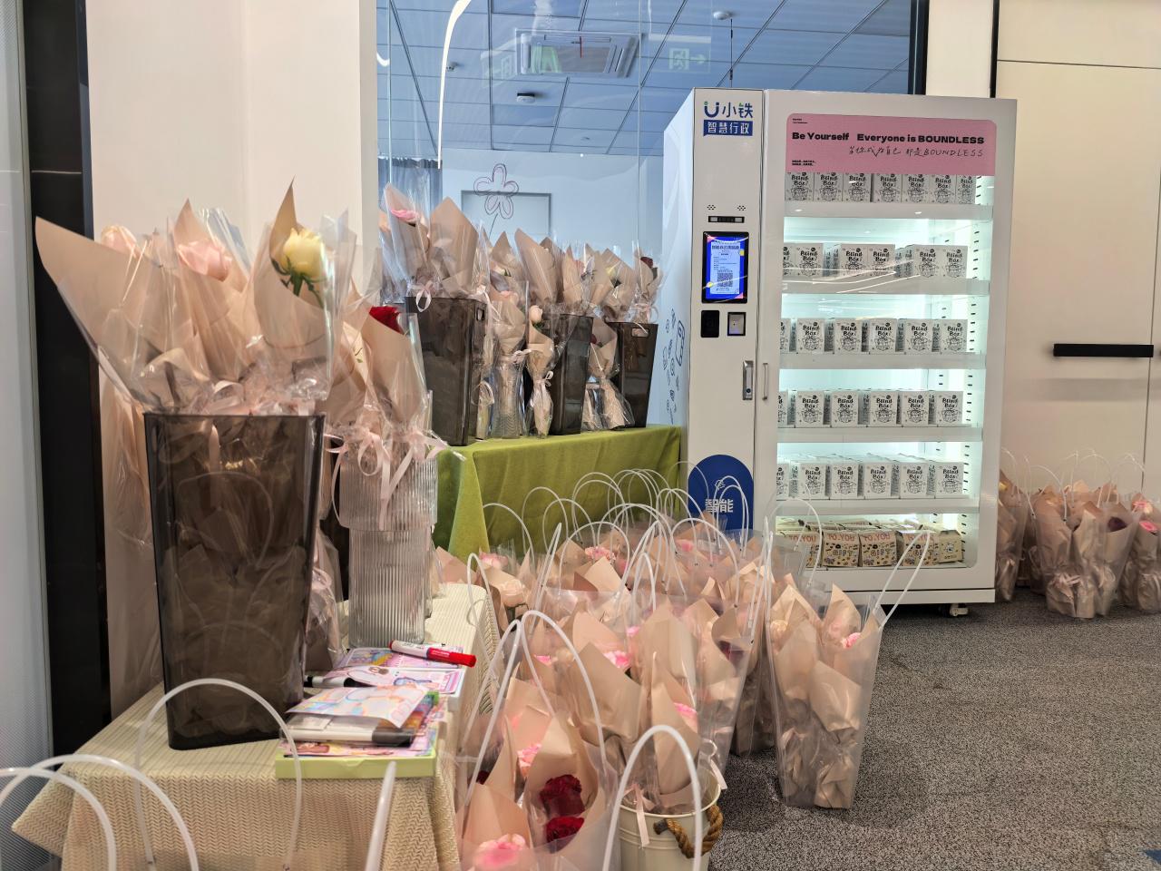 Office display of wrapped flower bouquets prepared for a Women’s Day event celebration.